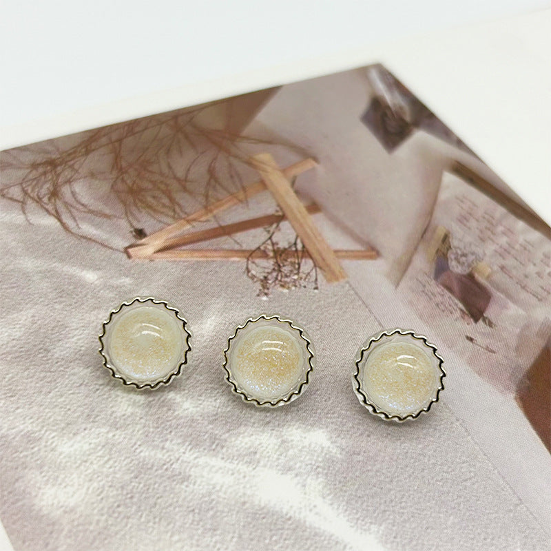 White glitter round buttons with scalloped metal rim and two shank grooves