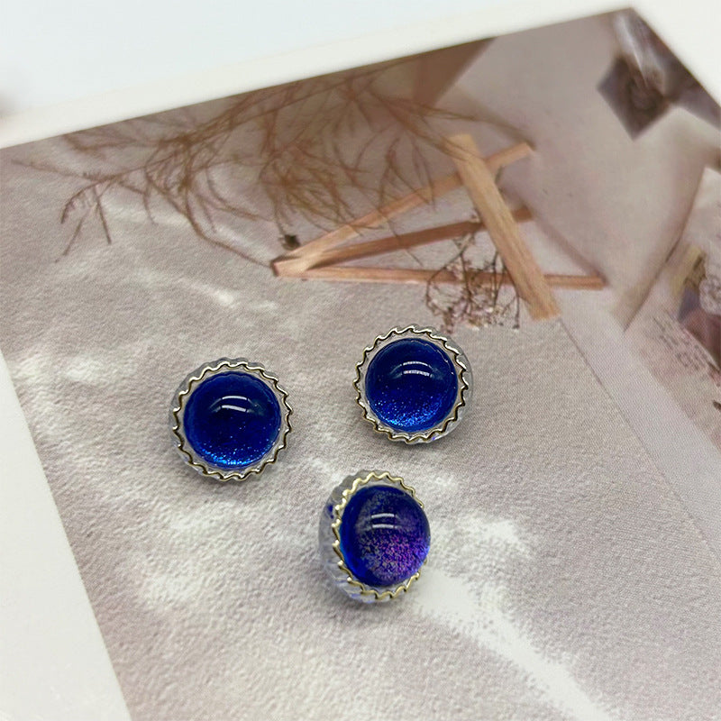 Blue glitter round buttons with scalloped metal rim and two shank grooves