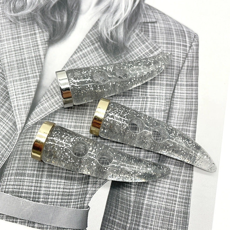 Silver glitter horn buttons with pearl sheen, gold metal bands, on fabric