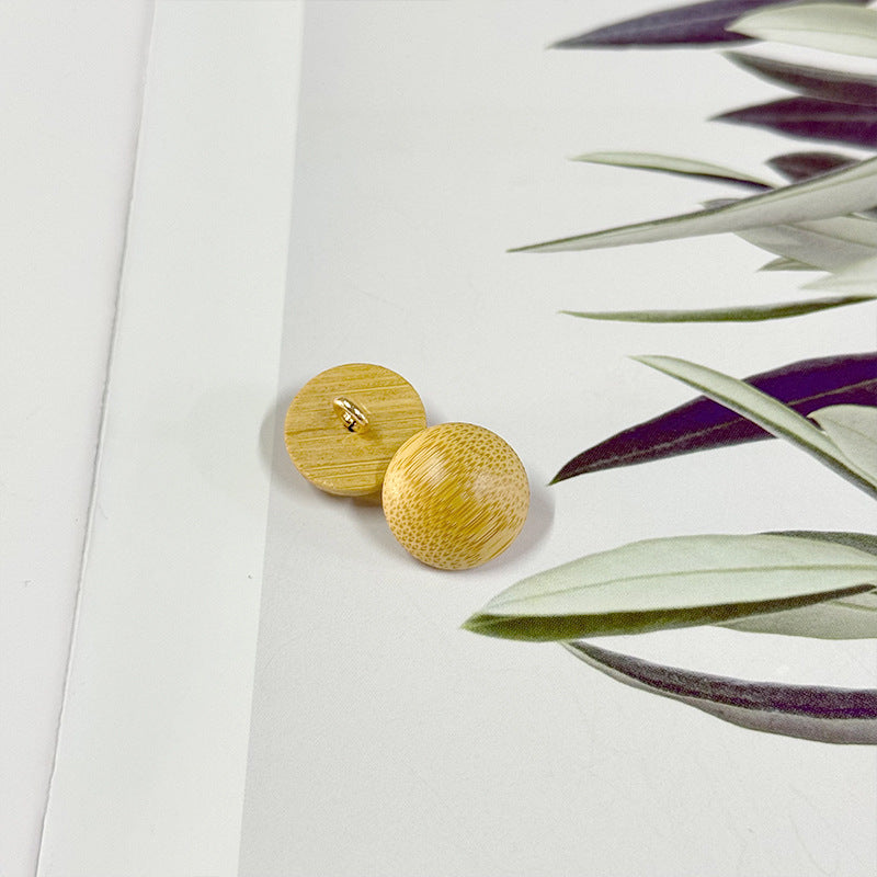 Natural round bamboo mushroom buttons with metal shanks, three buttons angled view