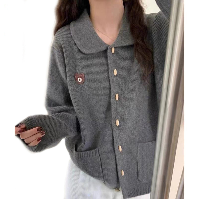 Olive-shaped bamboo button on dark gray knit cardigan, metal loop shank