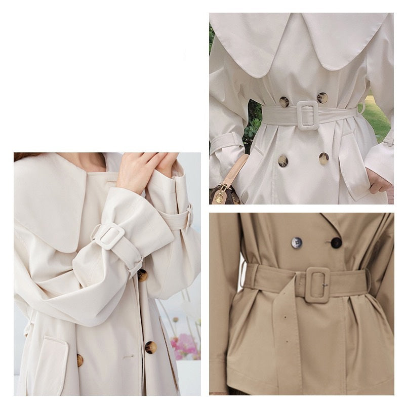 Fabric-covered D-ring buckle securing a coat belt cuff strap, light color
