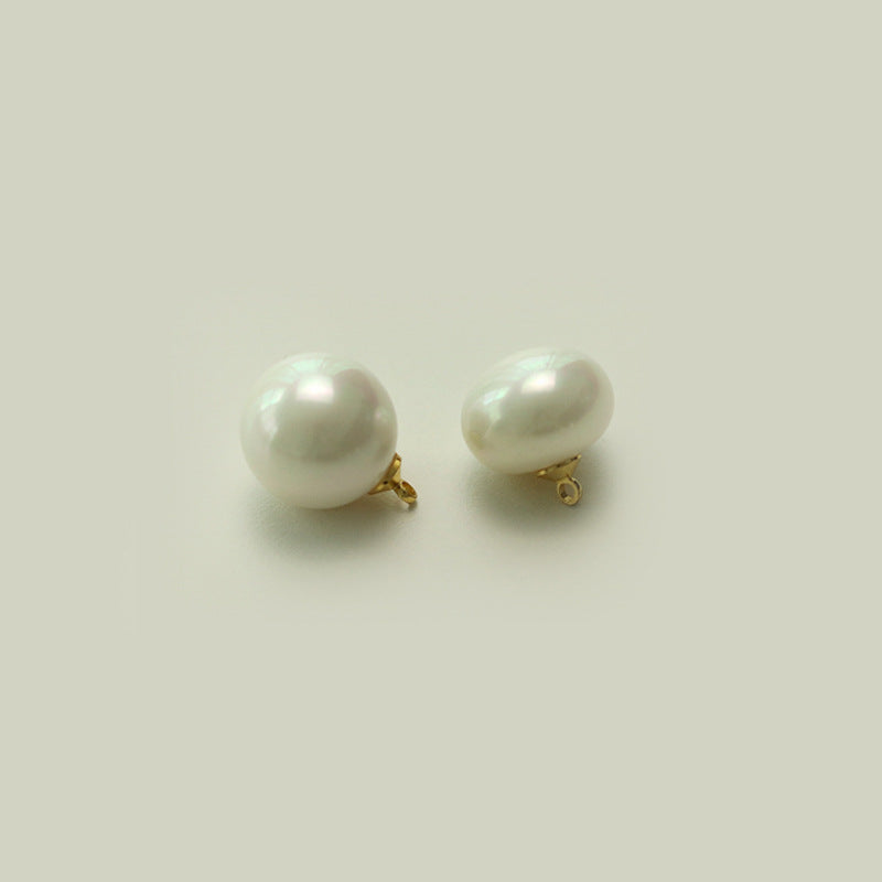 Two round oblate white pearl buttons with gold-tone metal shanks
