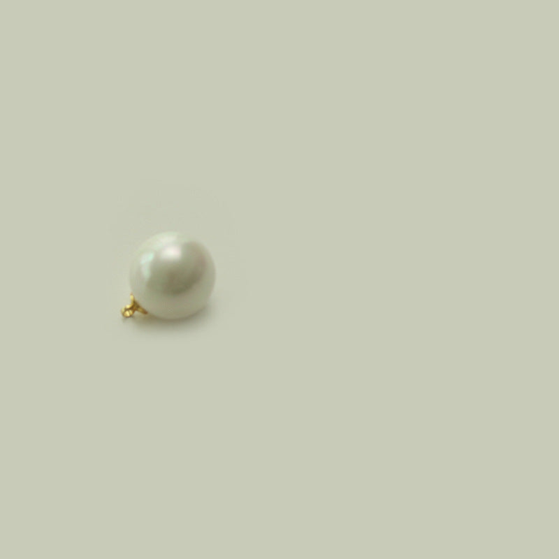 Round oblate white pearl button with gold-tone loop shank, underside view