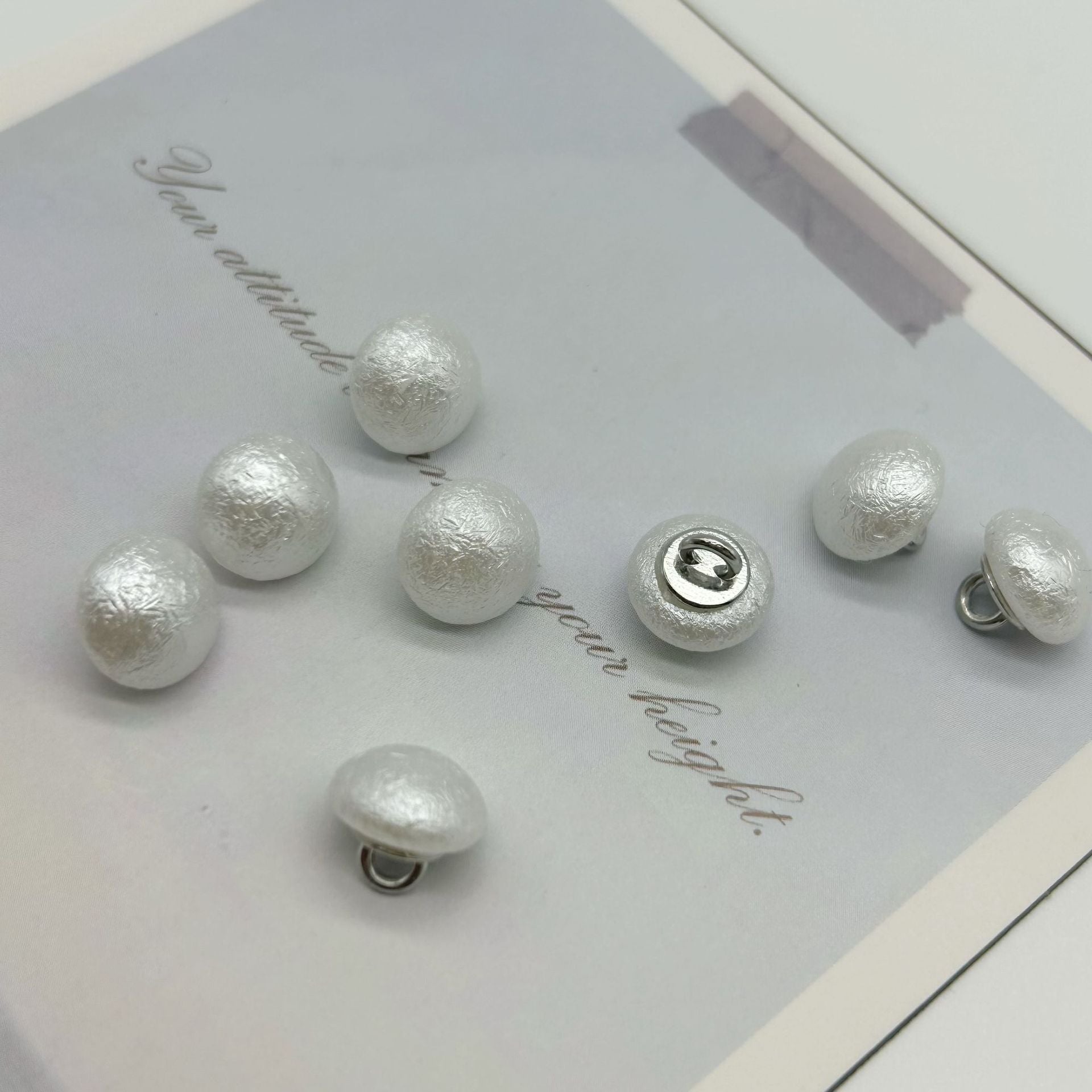 Assorted round wrinkled pearl buttons, silvery white, metal loop backs