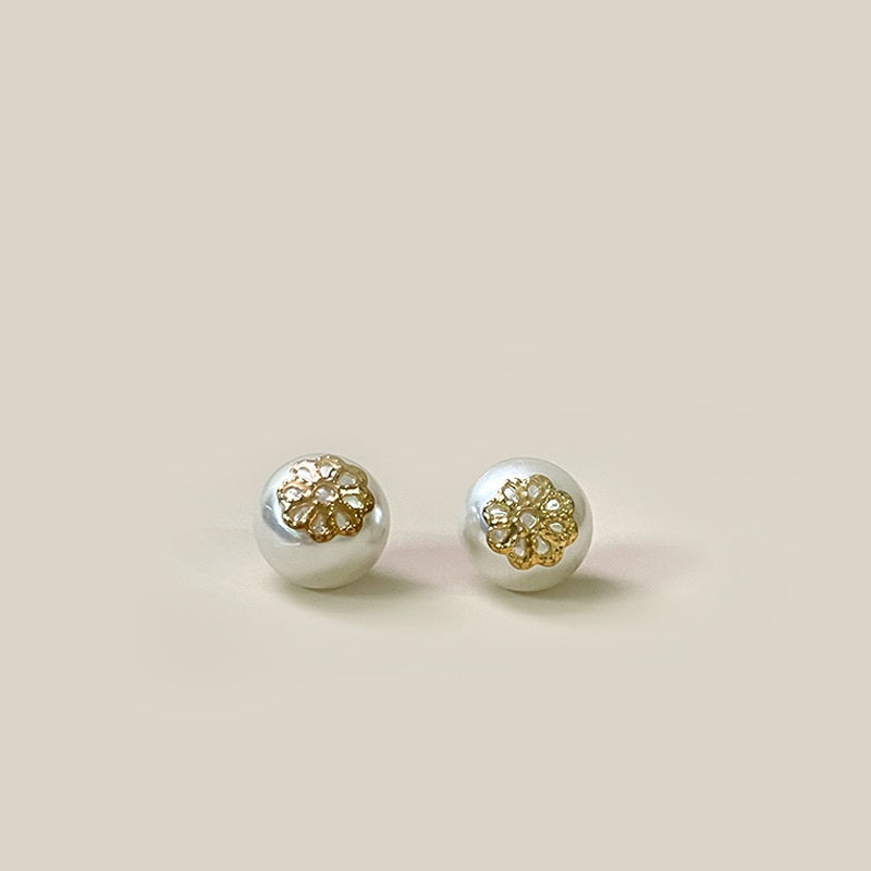Pair of 10mm white pearl flower buttons with gold-tone shank, front view