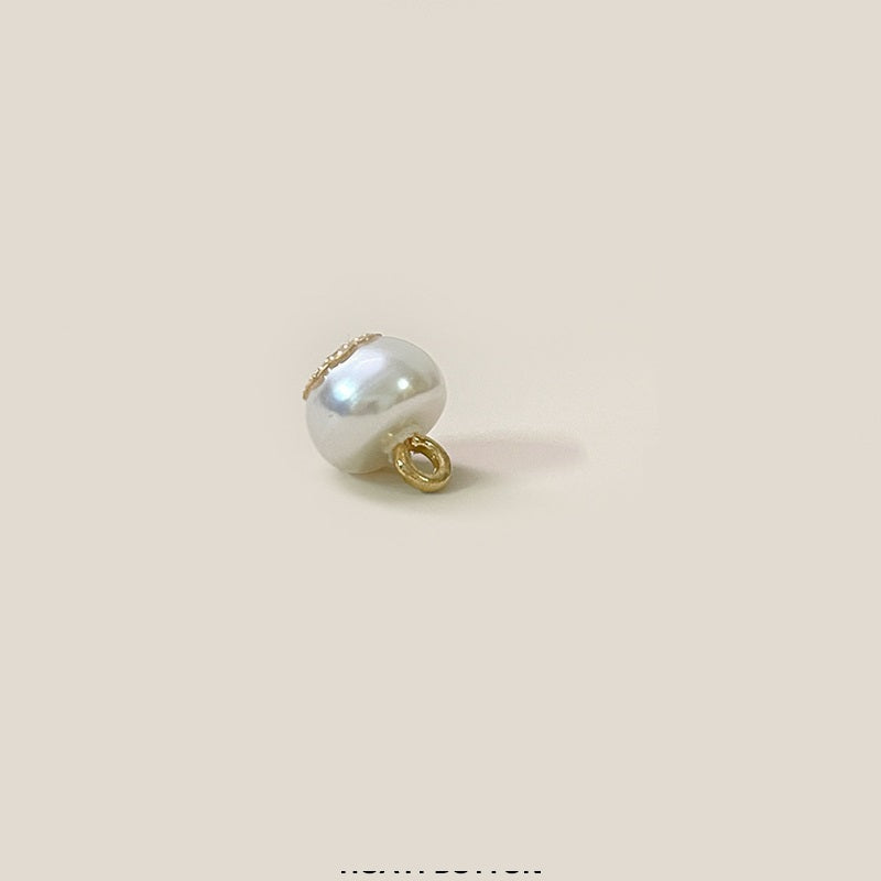 White pearl flower button back view with gold-tone loop shank