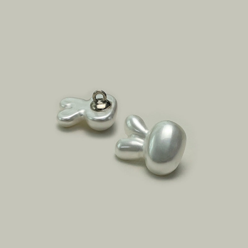 Plastic character buttons with metal shanks, rabbit/mouse motif, glossy light gray, back view