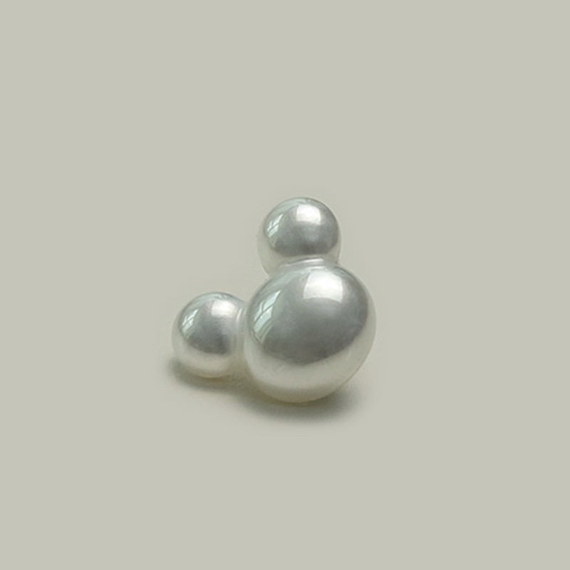Single cartoon character plastic button with metal shank, glossy light gray, front close-up