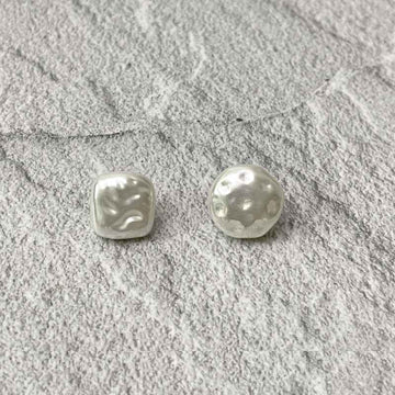 White pearl square and round buttons with metal shanks, front close-up