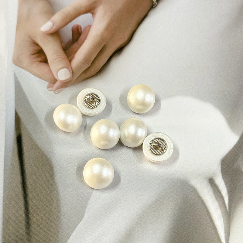 White pearl buttons, 11.5mm, round fronts on shirt fabric