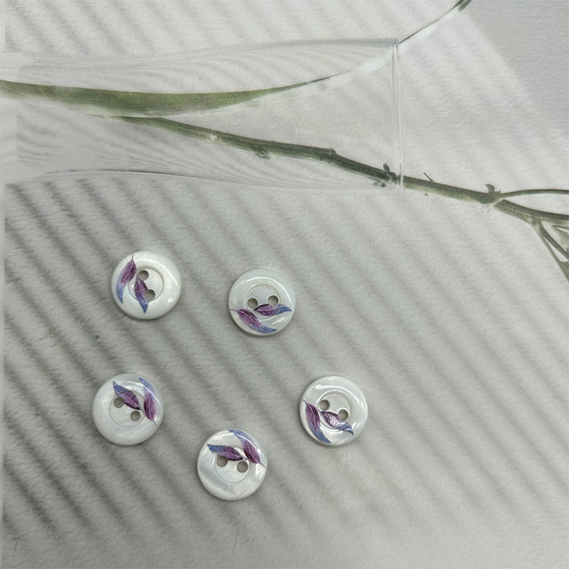 Round 2-hole shell buttons, white with blue-purple leaf motif