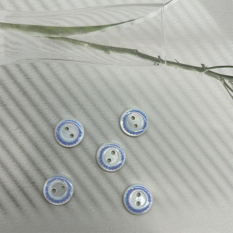 Round 2-hole shell buttons with blue ring border and light center holes