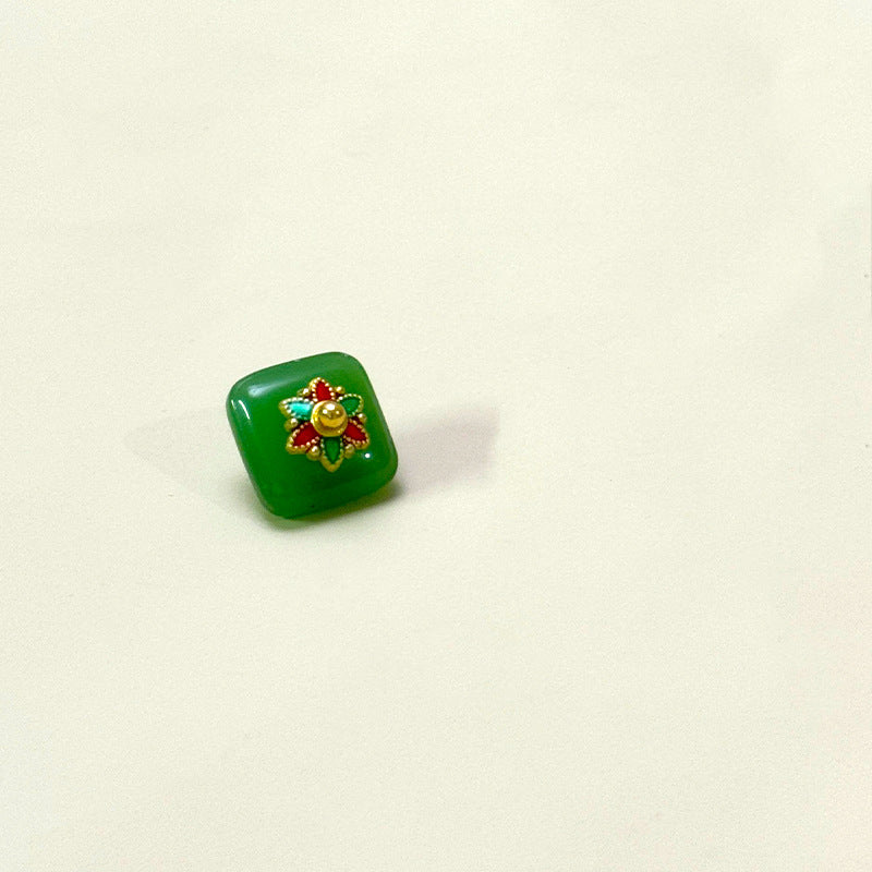 Square glass button with flower base, green with gold and turquoise accents