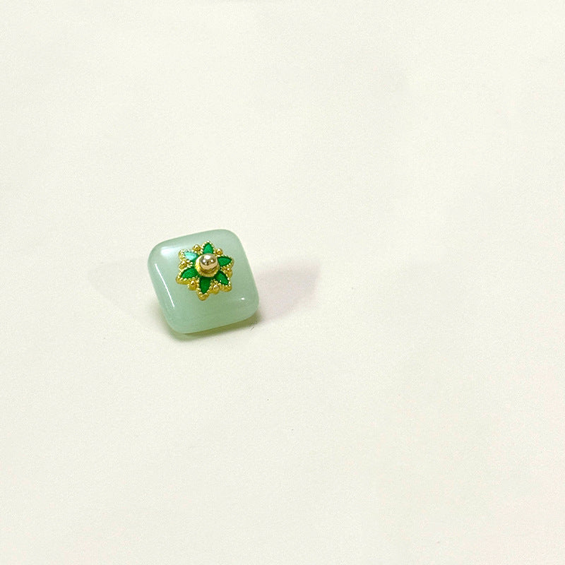 Square glass button with flower base, light mint green with gold flower