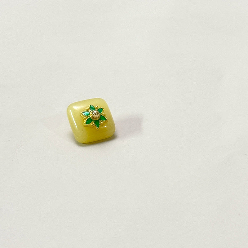 Square glass button with flower base, pale yellow-green with green gold flower