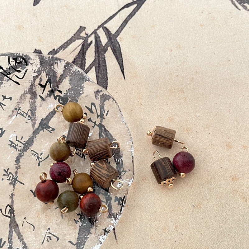 Mixed wooden bead charms with gold loops: dark brown and burgundy round beads.