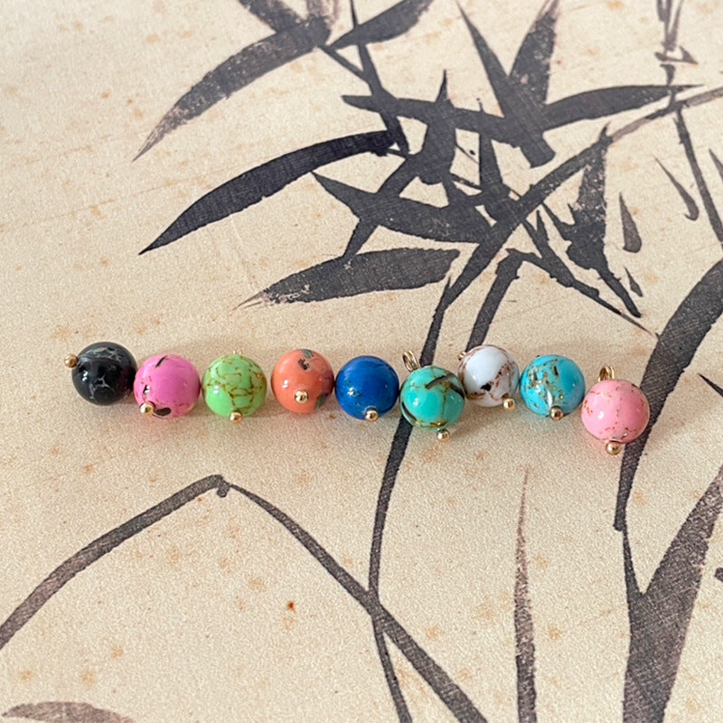 Mixed row of round jade-style buttons with gold-tone shanks in assorted colors