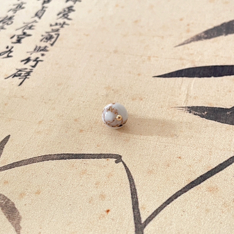 White jade-style round button with gold-tone shank, Chinese knot style