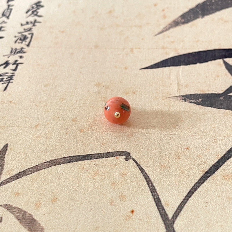 Jade-style Chinese button, coral pink with gold-tone shank holes