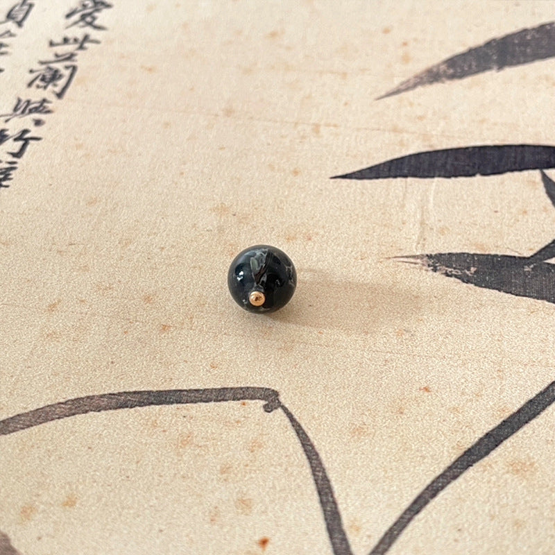 Jade-style Chinese button, dark navy/black with gold-tone shank holes