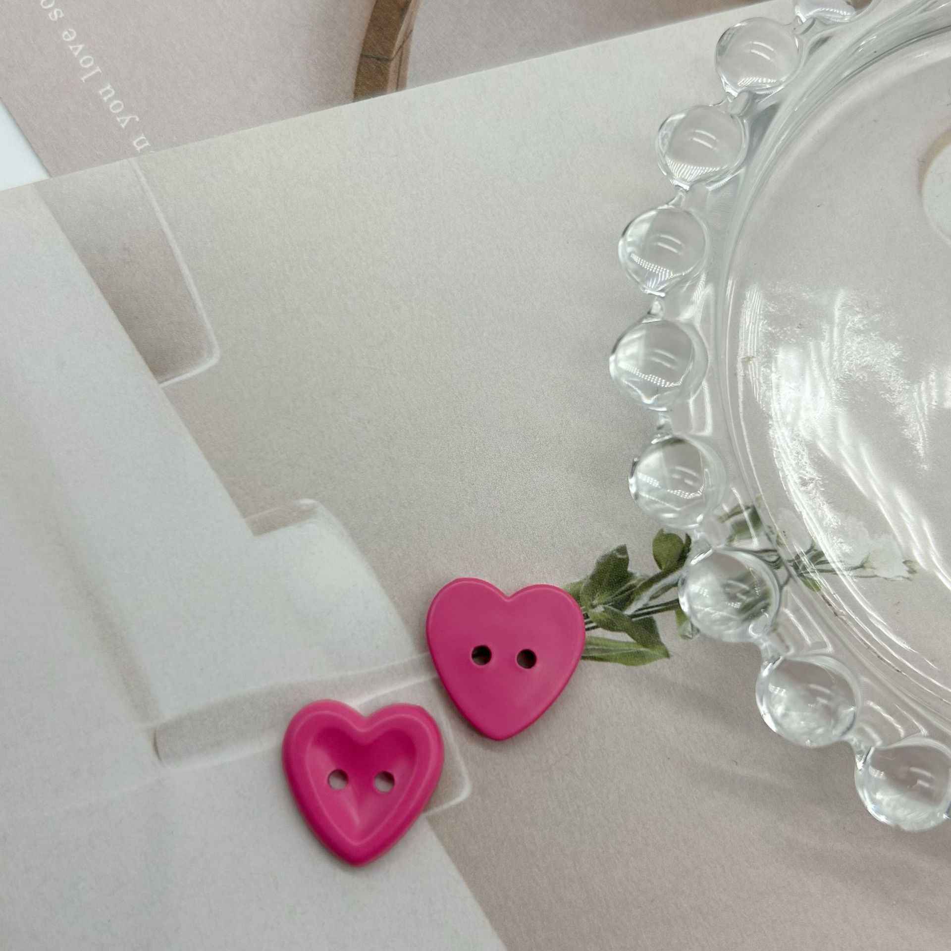 Two pink heart buttons with two holes for children’s sweater DIY