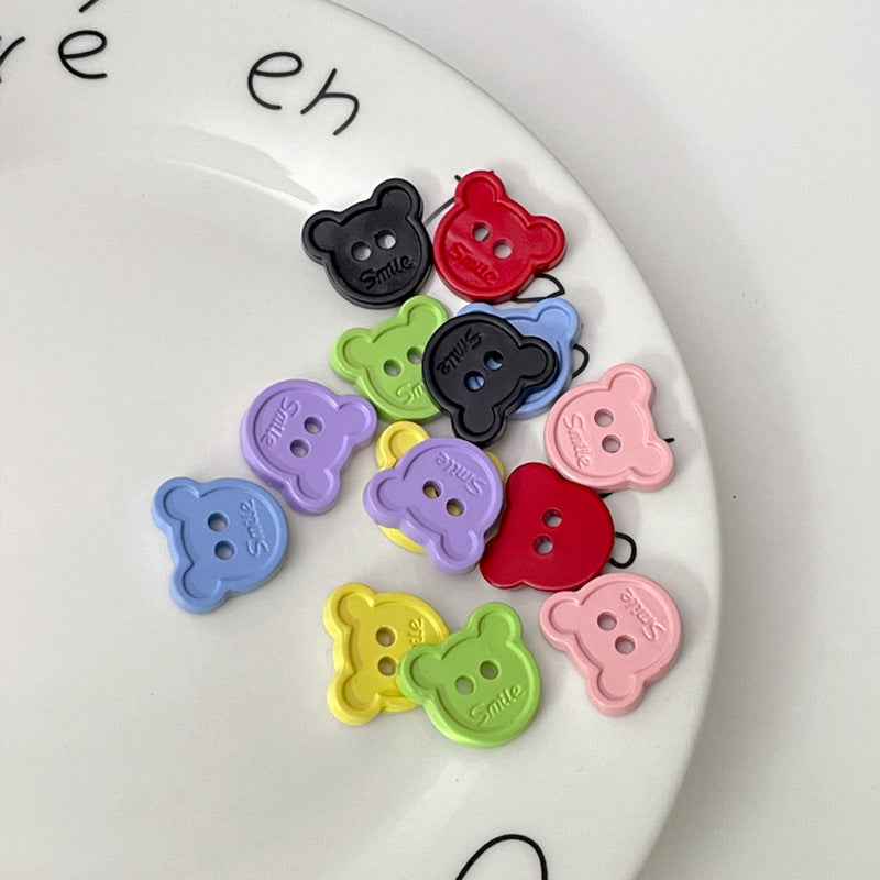 Set of cartoon teddy bear face plastic buttons in multiple colors, each with two holes