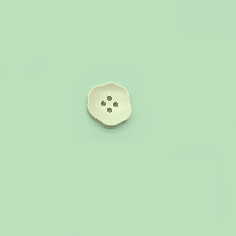 Ivory/cream flower-shaped 4-hole plastic button for children’s clothing