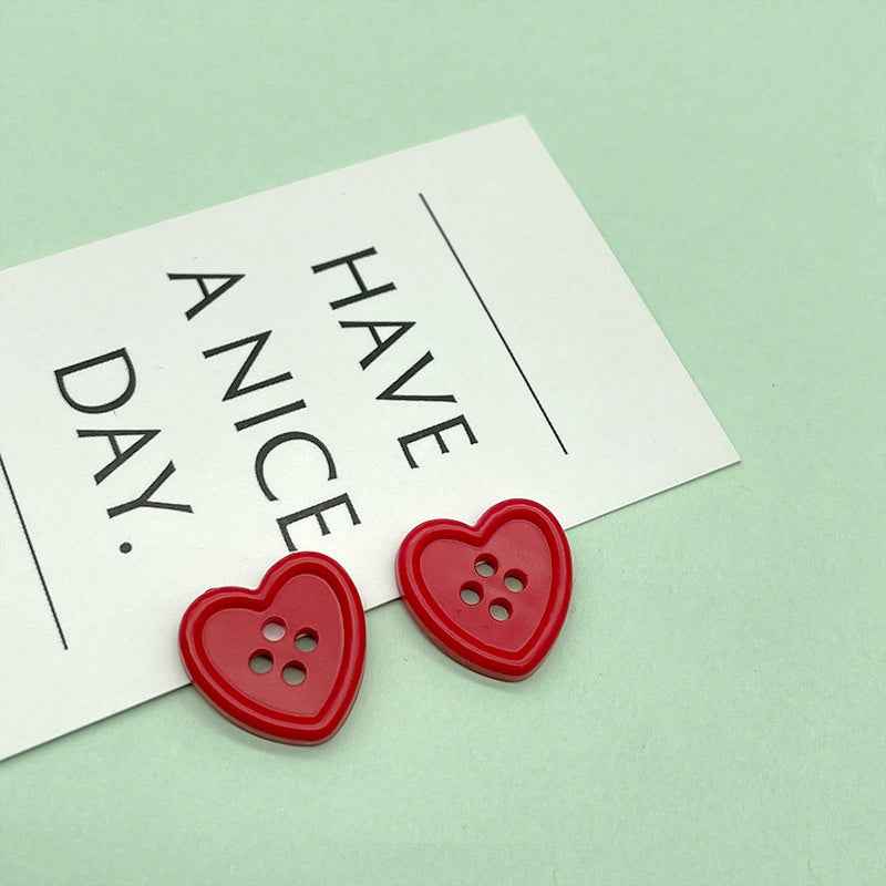 18mm four-hole heart buttons in red with four stitch holes
