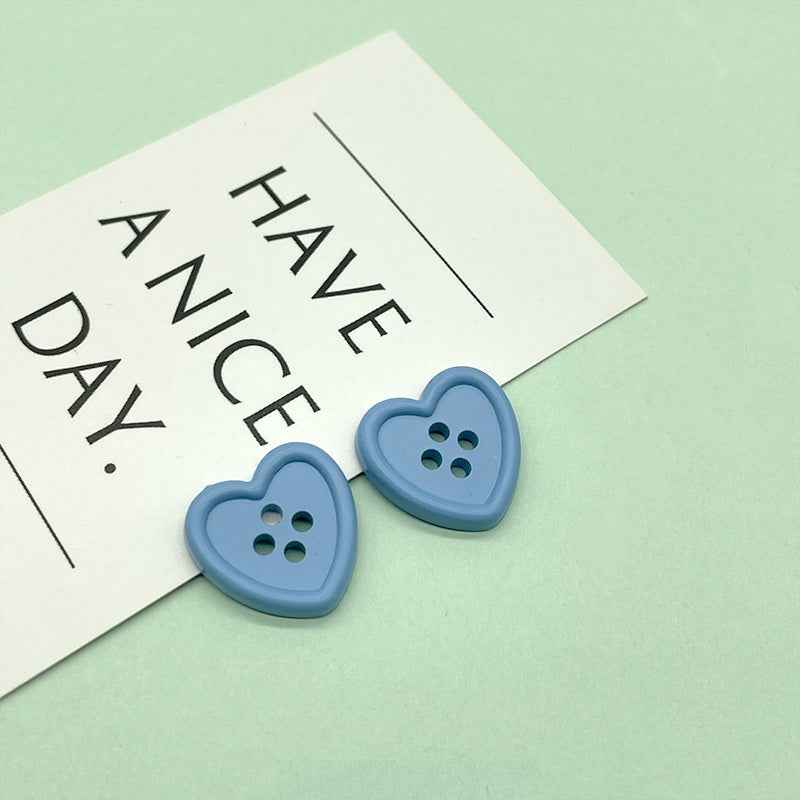 18mm four-hole heart buttons in light blue with four stitch holes