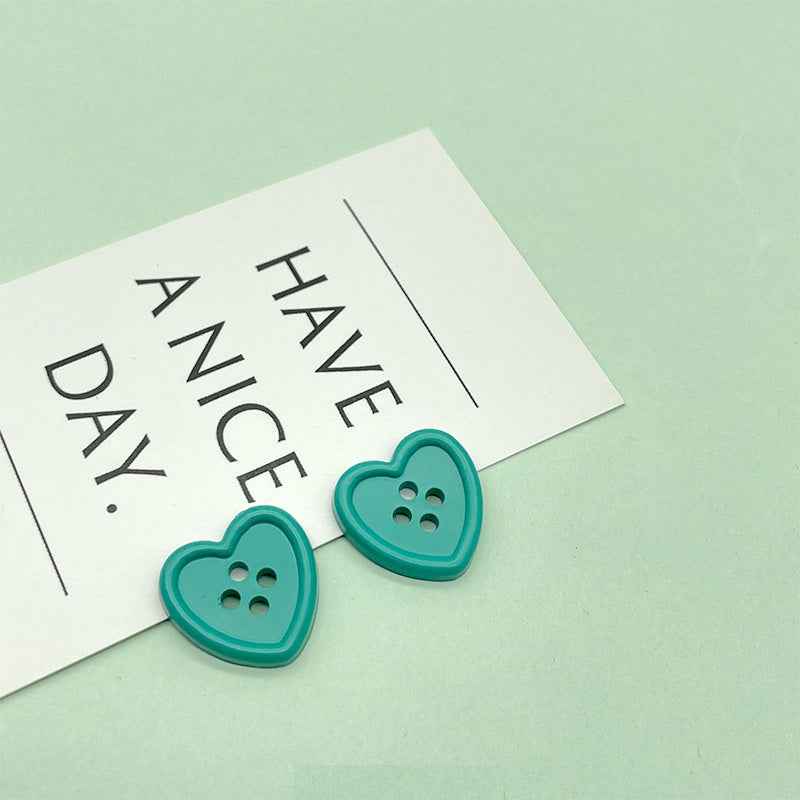 18mm four-hole heart buttons in teal/green with four stitch holes