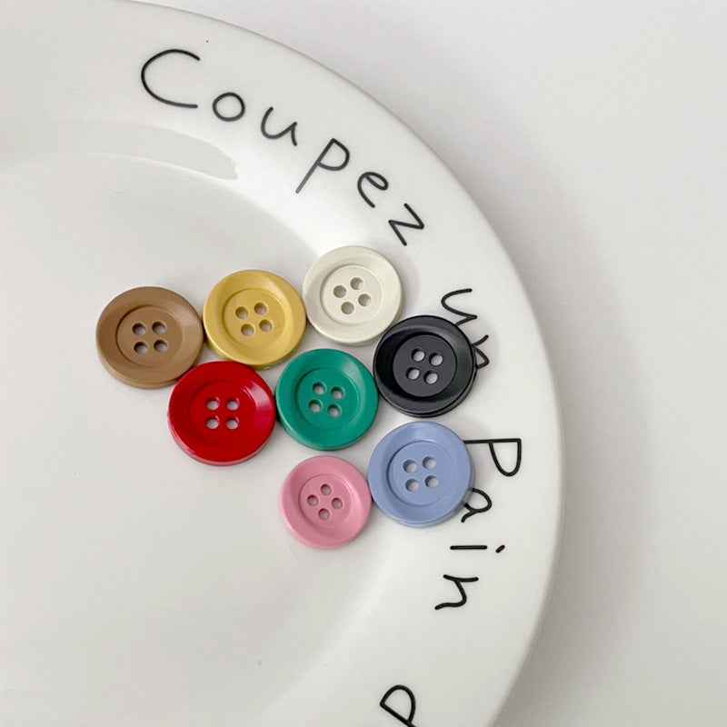 Four-hole circular plastic buttons assortment in multiple colors for kids’ clothing
