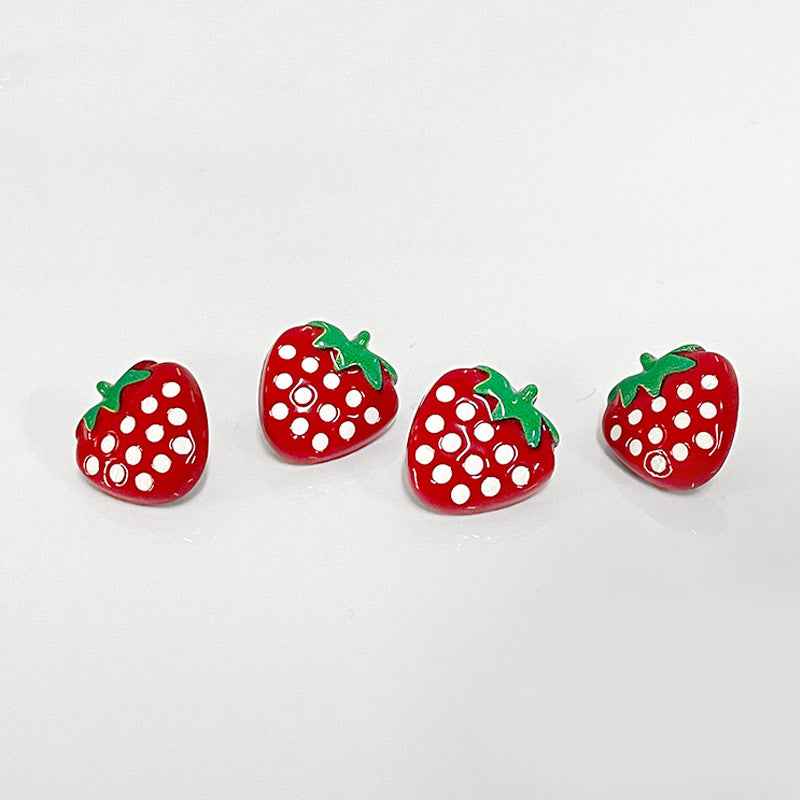 Set of red strawberry cartoon buttons with white dot pattern and green caps