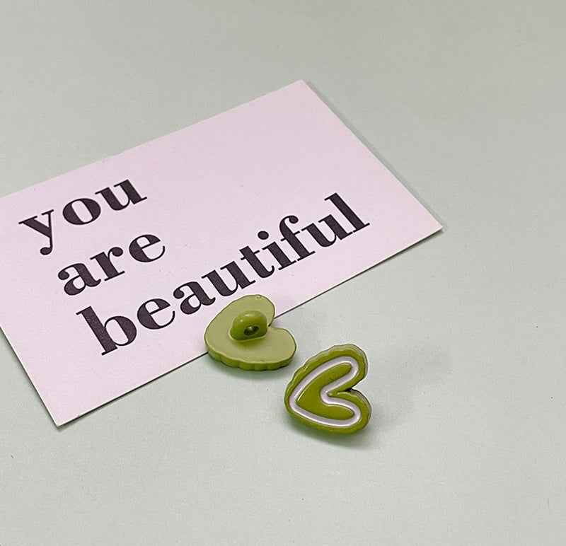 Light green double-heart plastic button with lime outline heart and flat back.