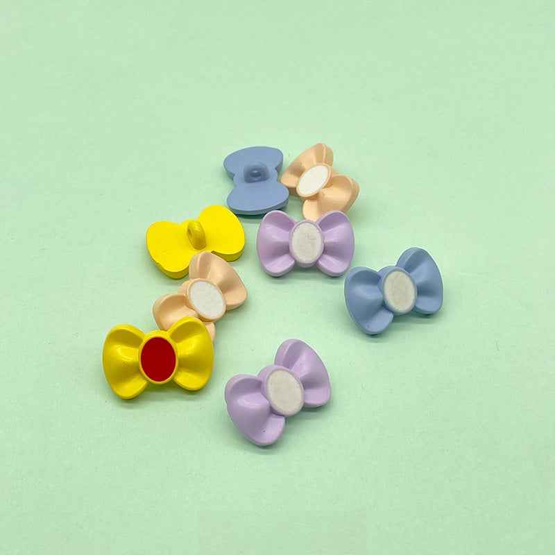 Bow-shaped plastic buttons, mixed colors: blue, beige, yellow, lavender, light blue