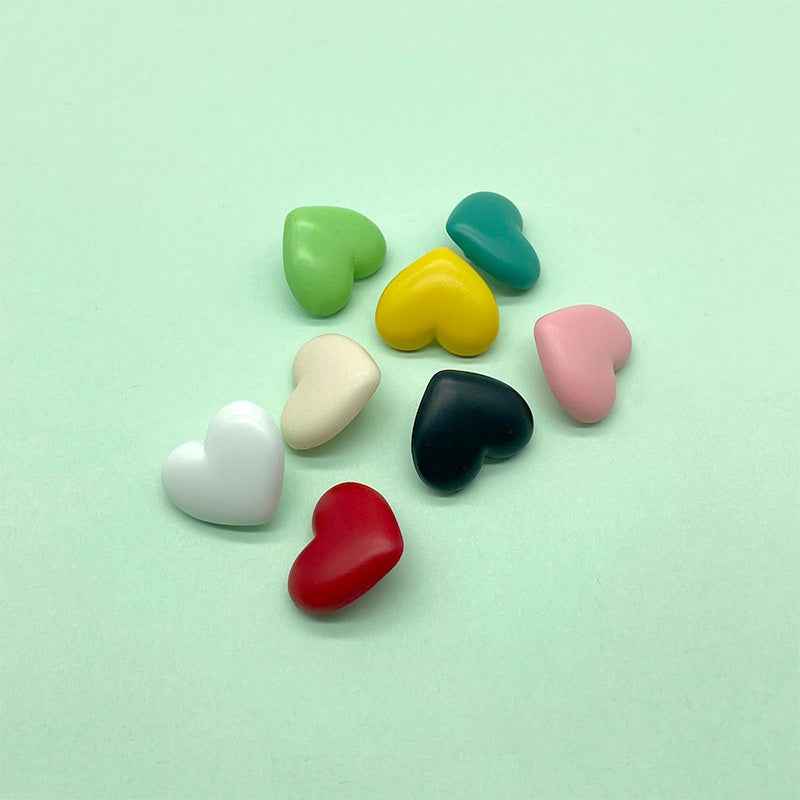 Heart-shaped plastic shank buttons—white, red, black, green, yellow, pink, teal hearts