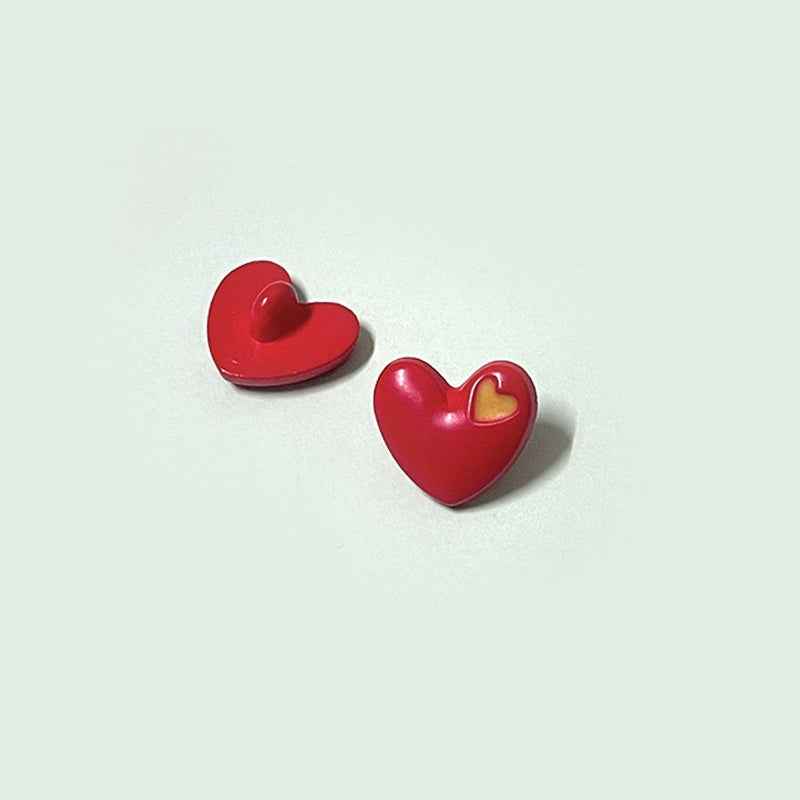 Red heart-shaped buttons with shanks and yellow inner-heart accent