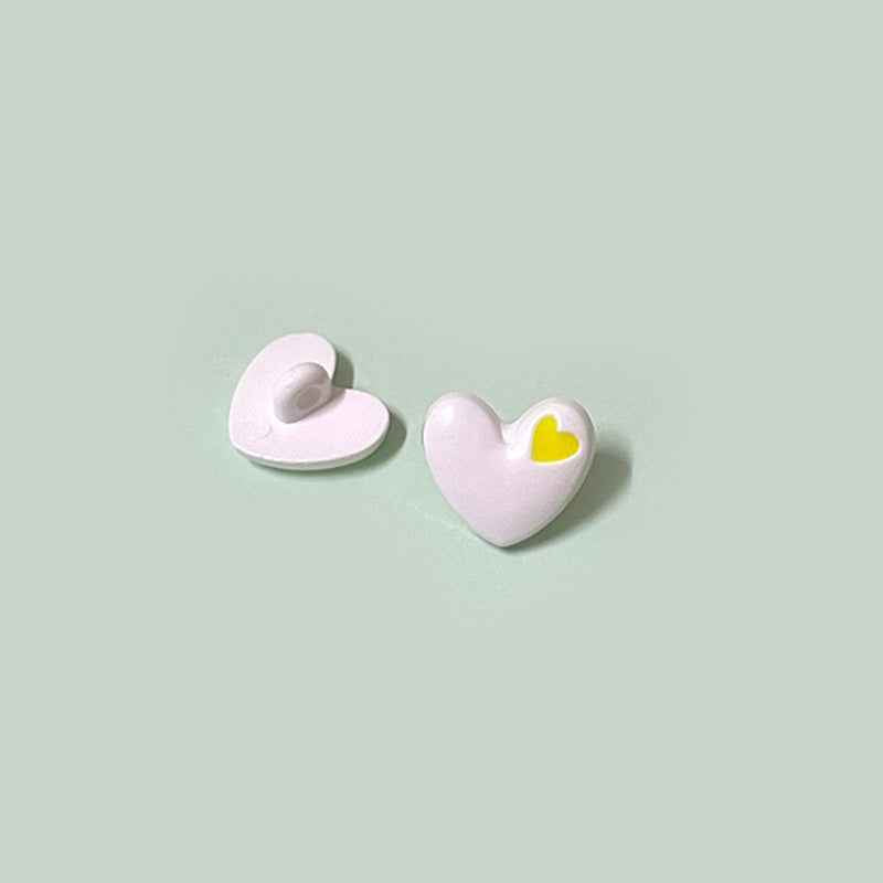 White heart-shaped buttons with shanks and yellow inner-heart accent, 15/18mm