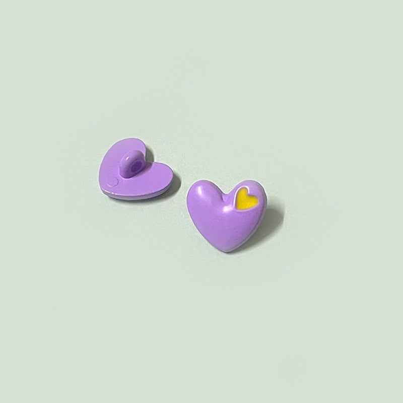 Purple heart-shaped buttons with shanks and yellow inner-heart accent
