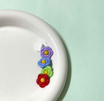 Colorful flower-shaped plastic shank buttons, blue purple green red with yellow centers