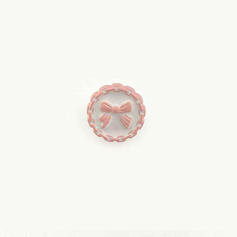 18mm plastic button with chain edge, pink translucent face, bow detail