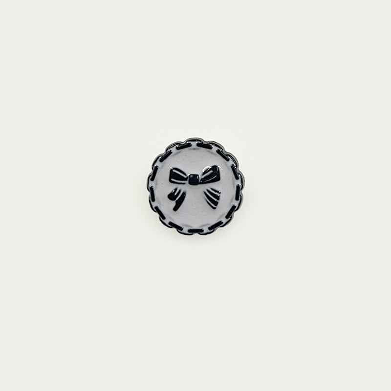 18mm plastic button with chain edge, white face, black bow