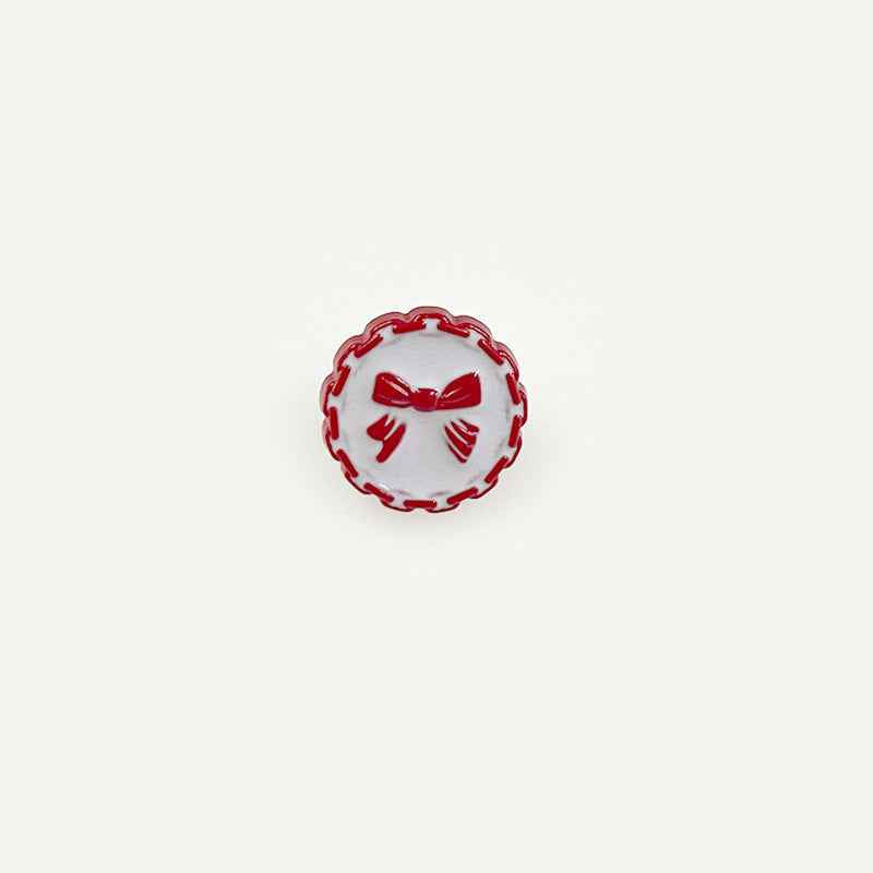 18mm plastic button with chain edge, red face, bow detail