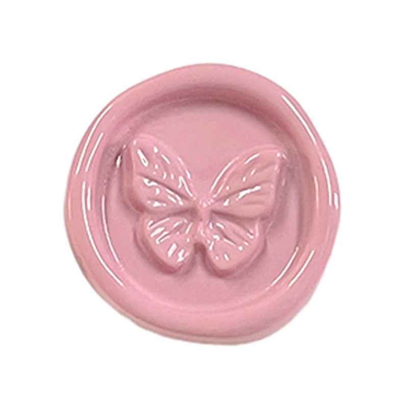 Pink round plastic shank button with embossed butterfly design