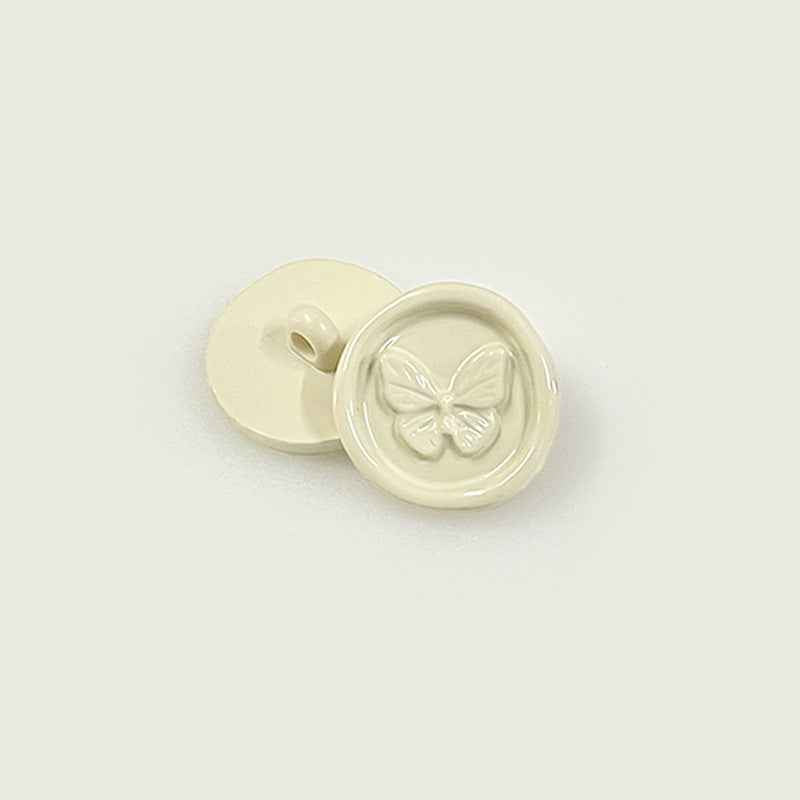 Cream round plastic shank buttons with butterfly embossed front