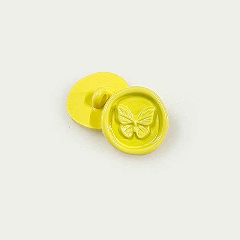 Yellow round plastic shank buttons with butterfly embossed front