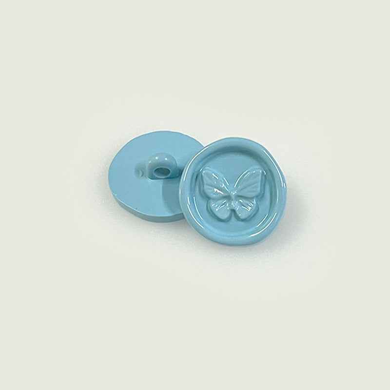 Light blue round plastic shank buttons with butterfly embossed front