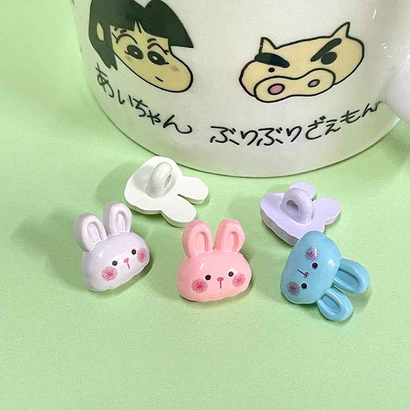 Cartoon bunny plastic buttons in white, pink, lavender, and blue with 2-hole back