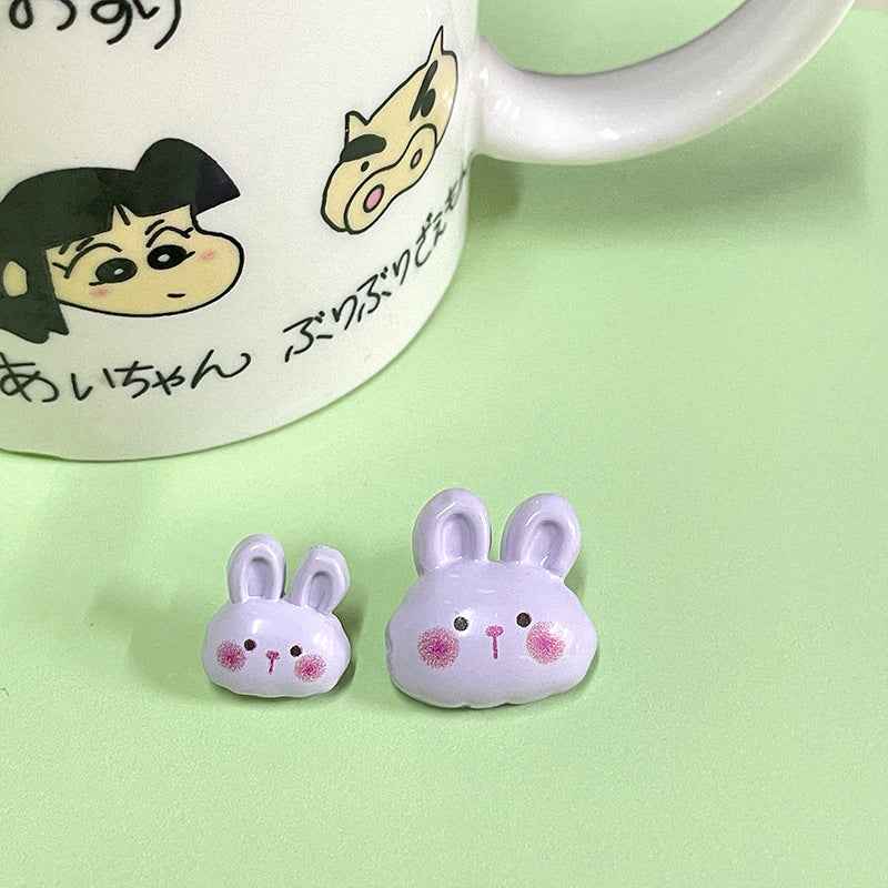 Two purple-lavender bunny plastic buttons with pink face accents and 2-hole back