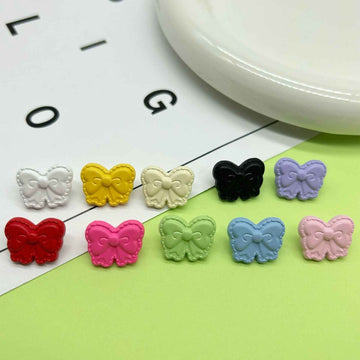 Colorful butterfly-shaped children’s shank buttons, assorted colors on display